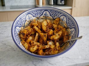 A large bowl of potatoes with spices