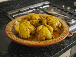 Marinated chicken in a Moroccan bowl on the kitchen marble countertop