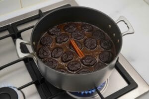 Caramelize the prunes with sugar, cinnamon, and water