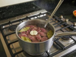Boiling chicken livers with bay leaves and garlic