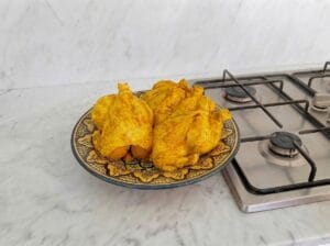 Marinating the chicken with a traditional Moroccan marinade in a yellow patterned Moroccan bowl