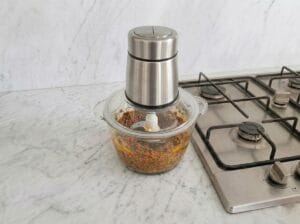 Blending the chicken liver with spices and eggs in a blender