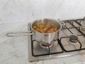 Simmering dried figs in honey in a separate pot over the stovetop