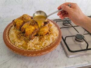 Arranging the chicken over the trid and pouring more thickened broth on top