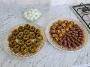 A platter of dates stuffed with almonds, honey-glazed dried figs stuffed with walnuts, a platter of steamed
