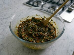 A glass bowl containing prepared Moroccan chermoula sauce