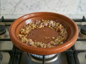 A Moroccan tagine with a little oil and golden, caramelized onions