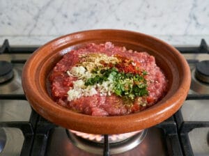 A traditional Moroccan tagine with fresh tomato sauce and aromatic spices
