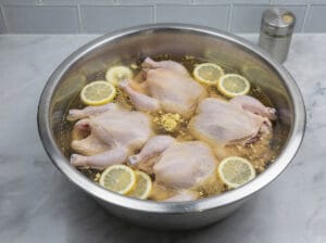 chicken marinated in water and ginger and vinegar in a marble kitchen