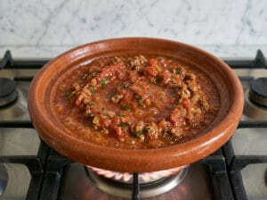 A traditional Moroccan tagine with a rich, cooked-down tomato sauce