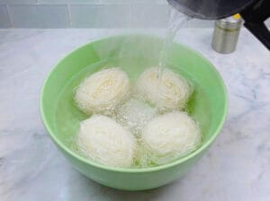 large bowl filled with Chinese vermicelli and boiling water
