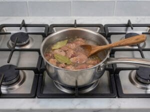 half-boiled chicken liver with water and bay leaves and garlic