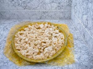 "Moroccan fish pastilla (bastilla) in a baking dish, featuring layers of crispy warqa pastry, filled with vermicelli noodles, and topped with perfectly cooked white fish fillet