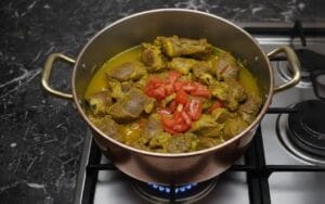 A pot of meat tenderly cooked in rich couscous broth with tomatoes