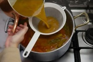 Combining and straining the meat broth with the couscous vegetable broth