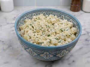 Diced potatoes with grated cheese, mayonnaise, and chopped parsley