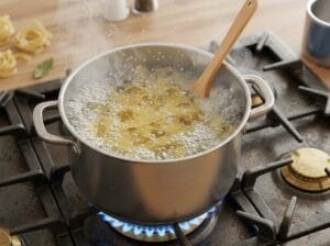 Fettuccine pasta boiling in a pot of water