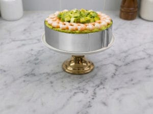Wheat salad in a serving bowl placed on a serving plate with a stand