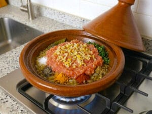 Tagine base with golden onions, grated tomatoes, and aromatic chermoula spices