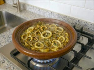 Traditional Moroccan tagine with calamari rings, onions, spices,