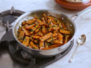 Carrot fingers mixed with chermoula in a pan
