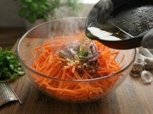 Hot oil poured over grated carrots and onions