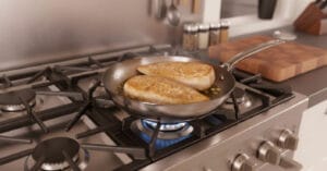 A pan with sautéed, golden-brown chicken slices