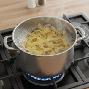 Fettuccine pasta boiling in a pot of water