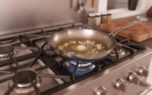 A pan with melting butter cubes and minced garlic