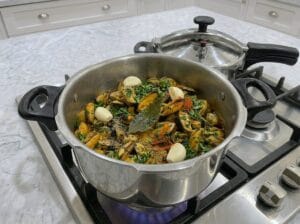 Cleaned mussels in a pressure cooker with garlic and spices