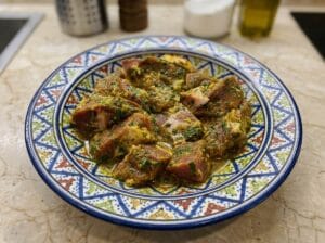 Decorative plate containing beef with spices and finely chopped parsley