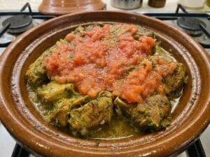 Meat in the tagine with spices, topped with grated tomatoes over the meat