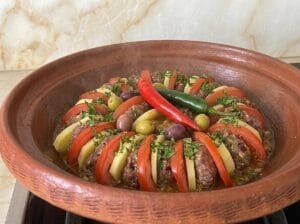 Decorating the vegetables with olives and green and red hot peppers