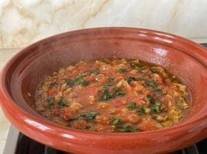 Tagine with well-cooked tomato sauce, onion, and parsley